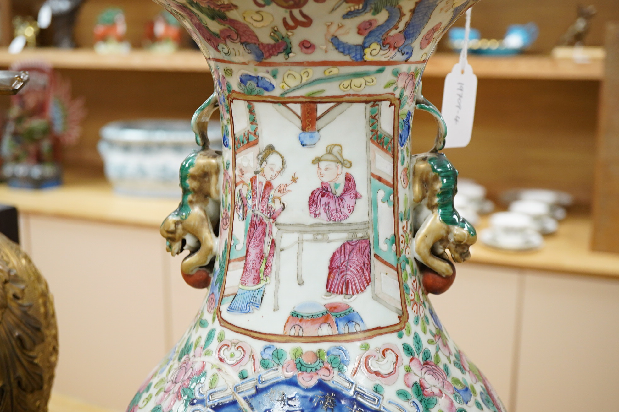 A large Chinese famille rose vase enamelled with figures and flowers, 59cm high (damaged and repaired)